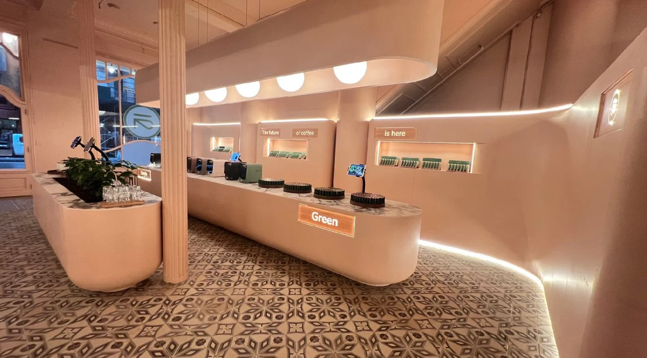 Ansa Coffee: Curved cafe counters beneath globe lighting, with fluted columns and patterned flooring